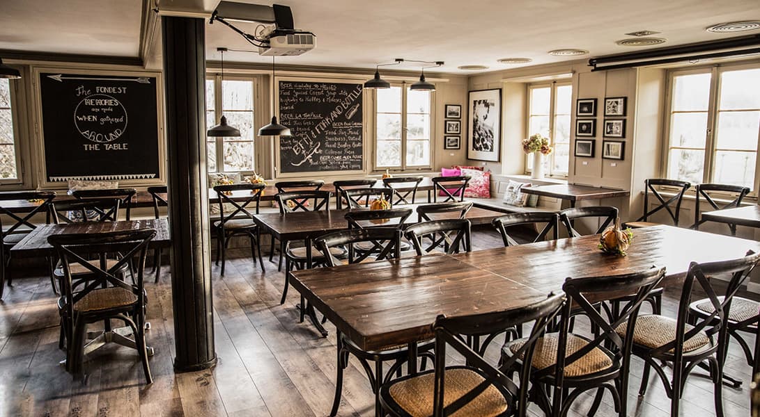 Cozy cafe with wooden tables and chairs.