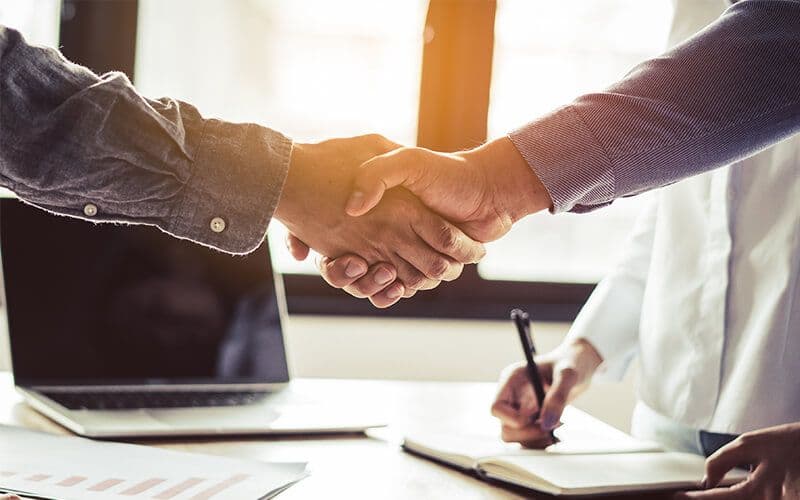 Handshake over a business agreement meeting