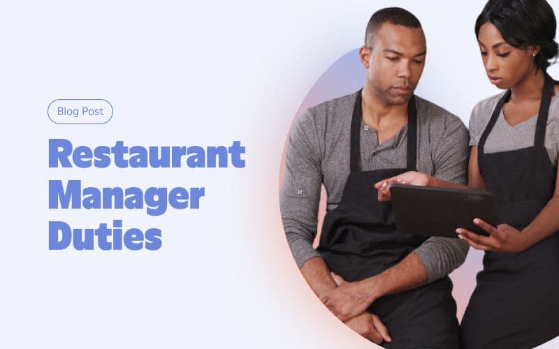 Two managers reviewing restaurant duties on tablet.