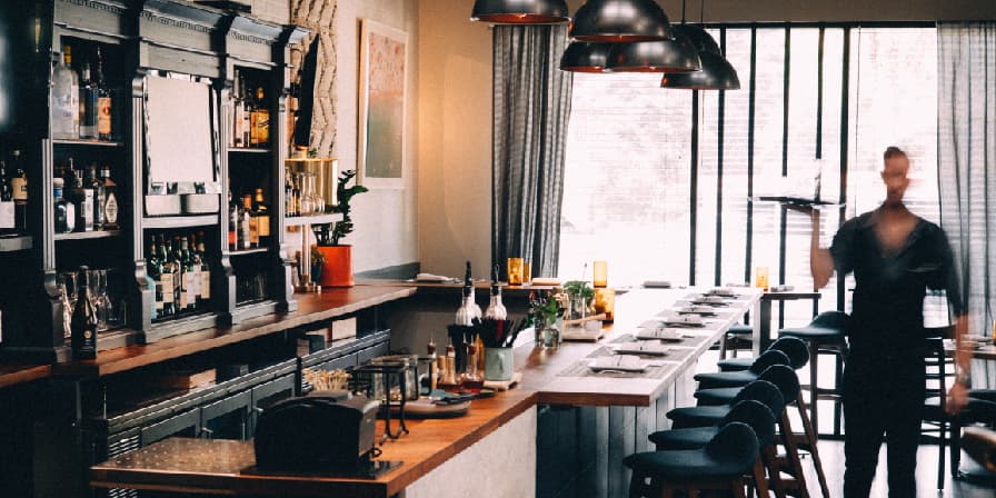 Cozy bar interior with dim lighting and seating.