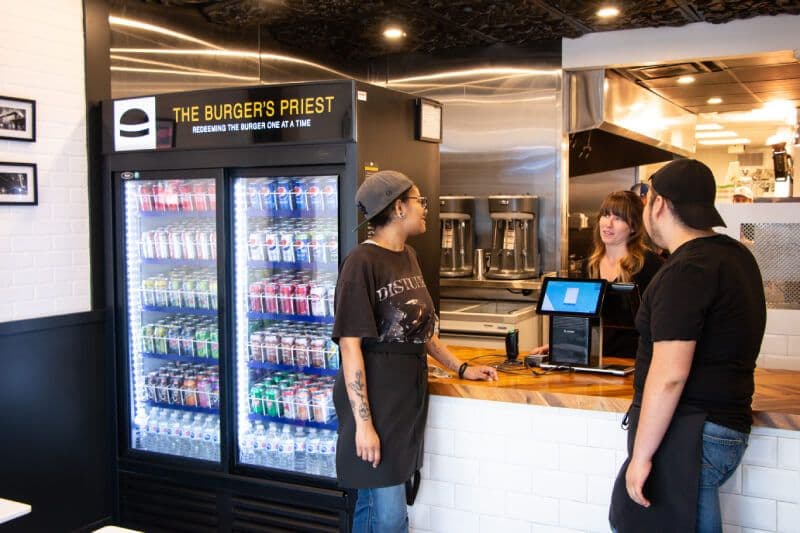 Burger restaurant staff talking at counter