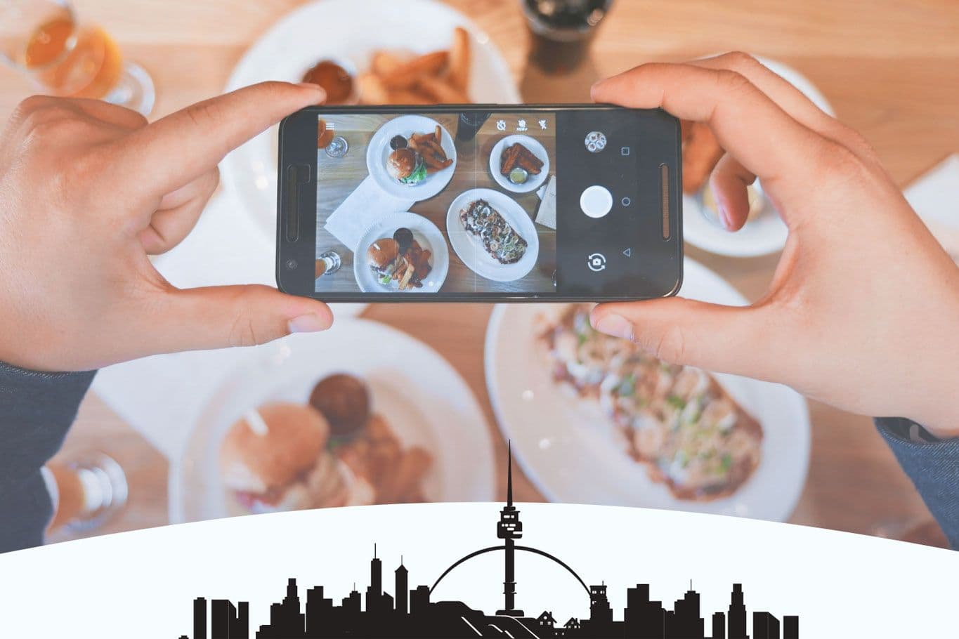 Person photographing food with smartphone in restaurant